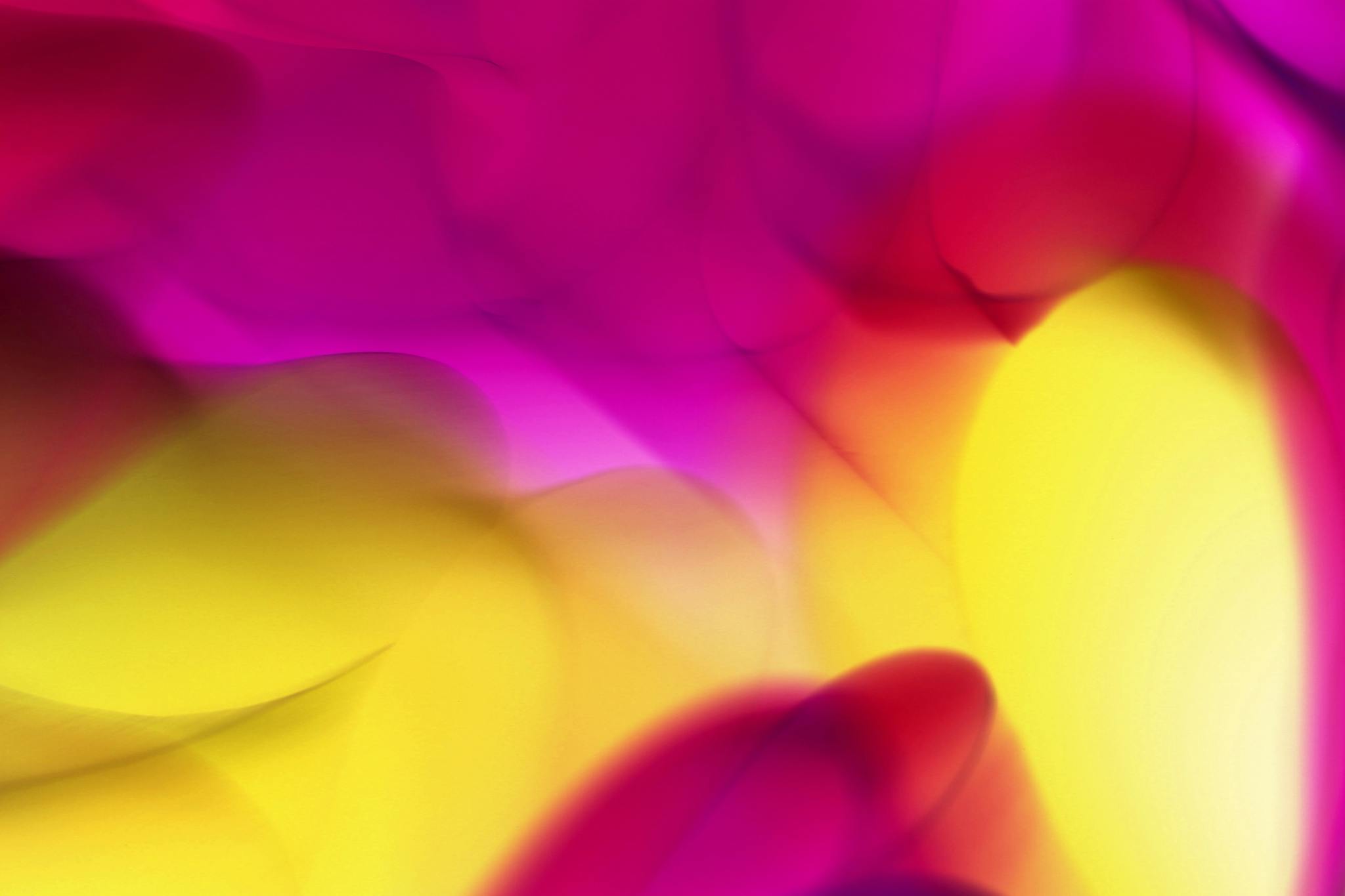 A captivating abstract design with vibrant pink, yellow, and red color waves.