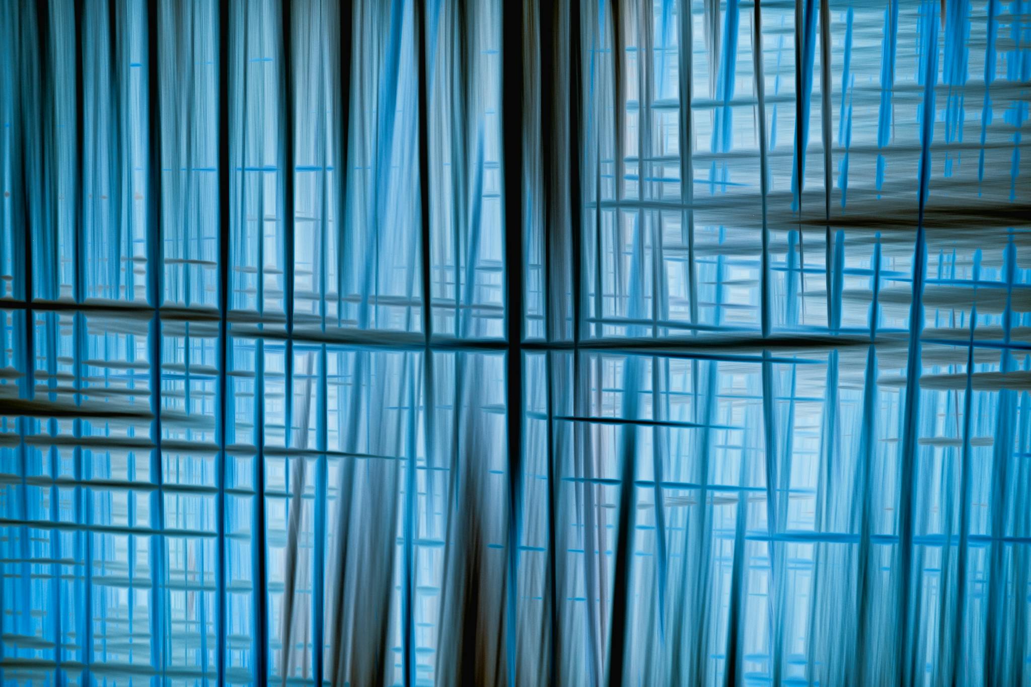 Dynamic abstract image featuring intersecting blue lines and patterns with a serene and modern feel.